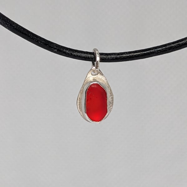 Tiny red sea glass sterling silver pendant
