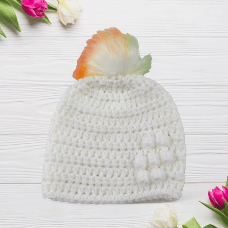 White baby crocheted hat white faux fur pompom with orange yellow & green 