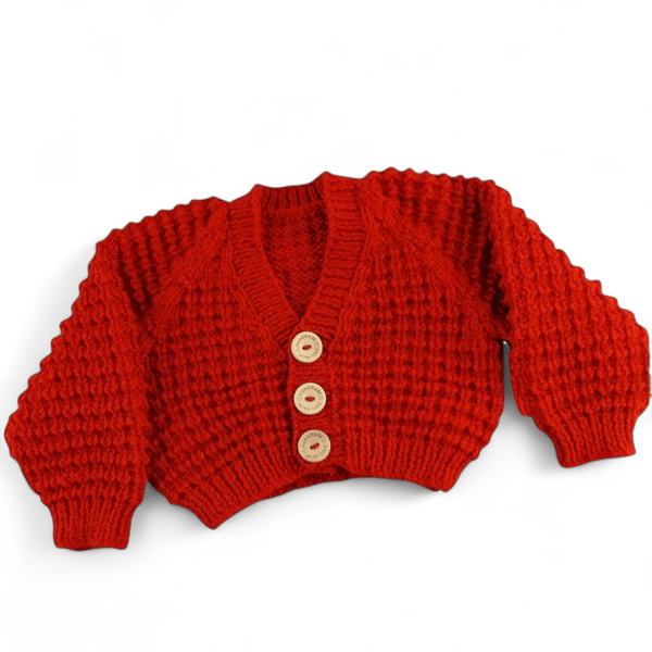 Hand knitted baby cardigan in fox red brown textured pattern 