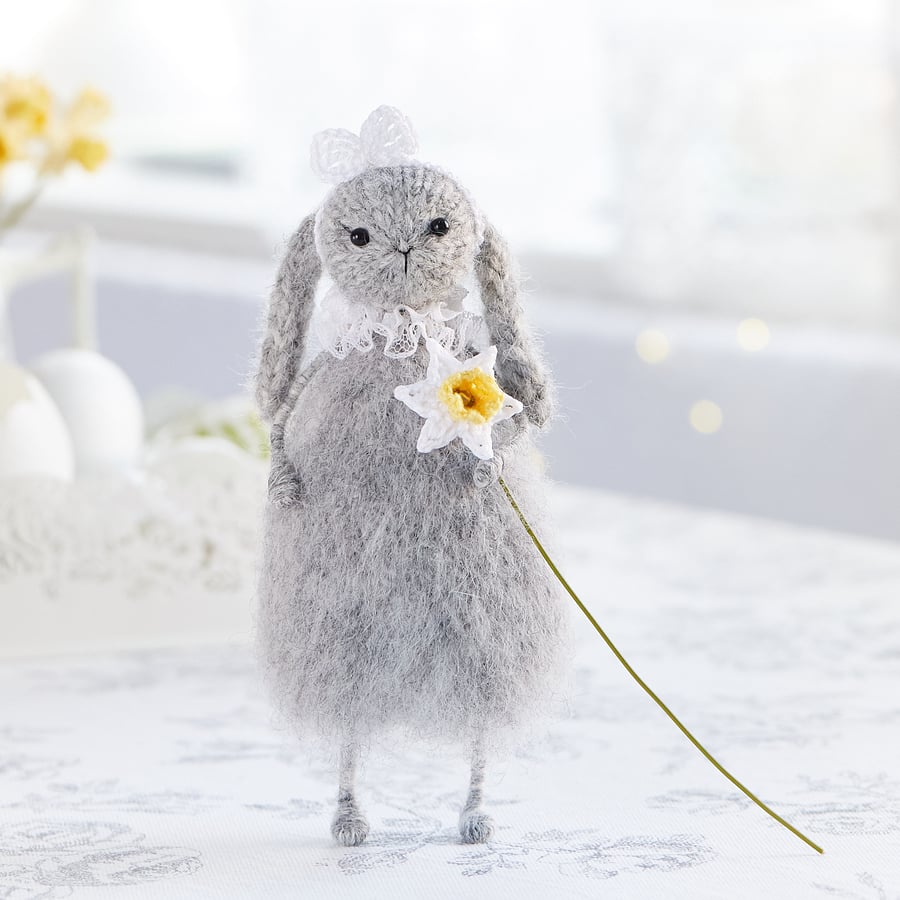 Easter bunny with a daffodil, knitted rabbit doll