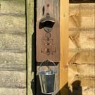Wall mounted bottle opener with bucket cap catcher (ship faced)