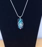 Emerald Glass and Silver Spiral Pendant - Image 1