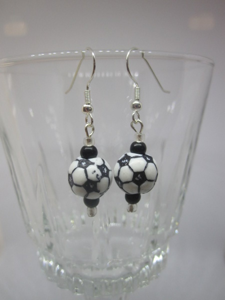 A Pair of Black and White Themed Earrings.