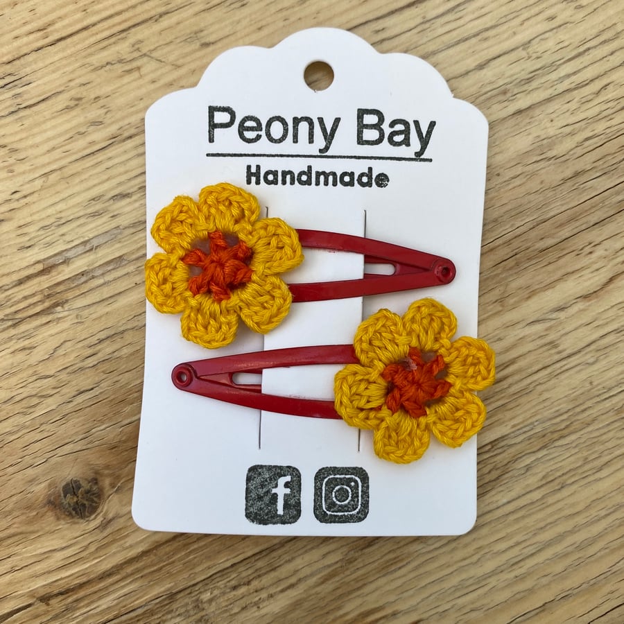 Girls flower hair clips in orange, yellow & red