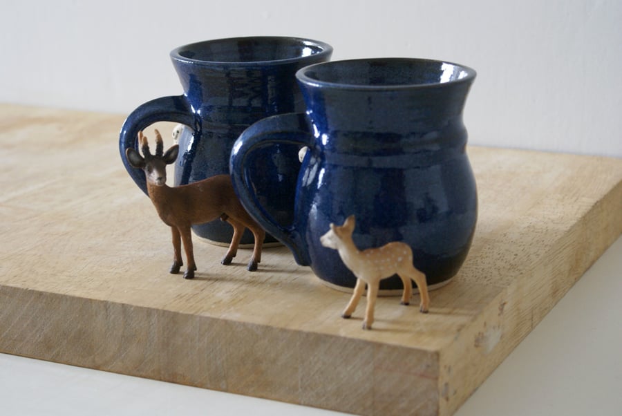 Two stoneware pottery coffee mugs - glazed in midnight blue with tiny mouse