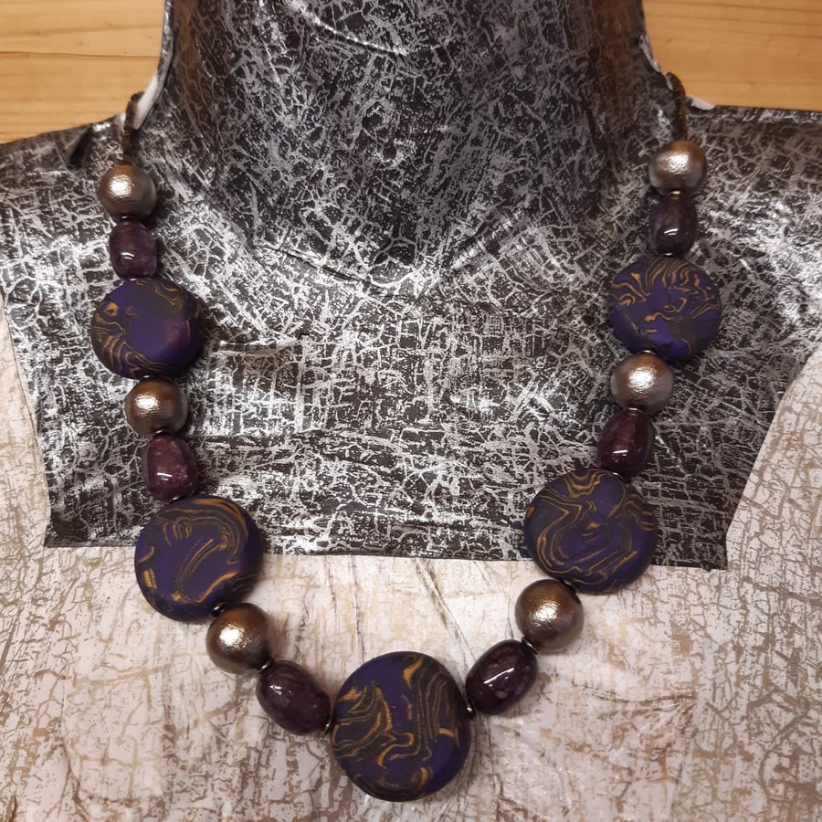 Purple, gold and black polymer clay disc shaped necklace 