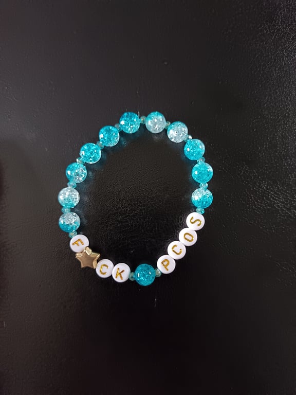 Elasticated PCOS letters bracelet with star detail and blue glass beads