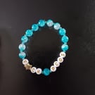 Elasticated PCOS letters bracelet with star detail and blue glass beads