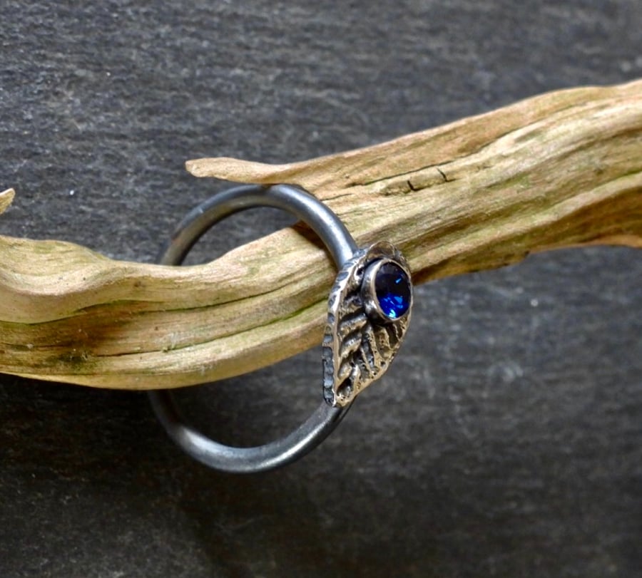 Leaf Charm Ring With a Blue Stone Black Oxidised Finish.