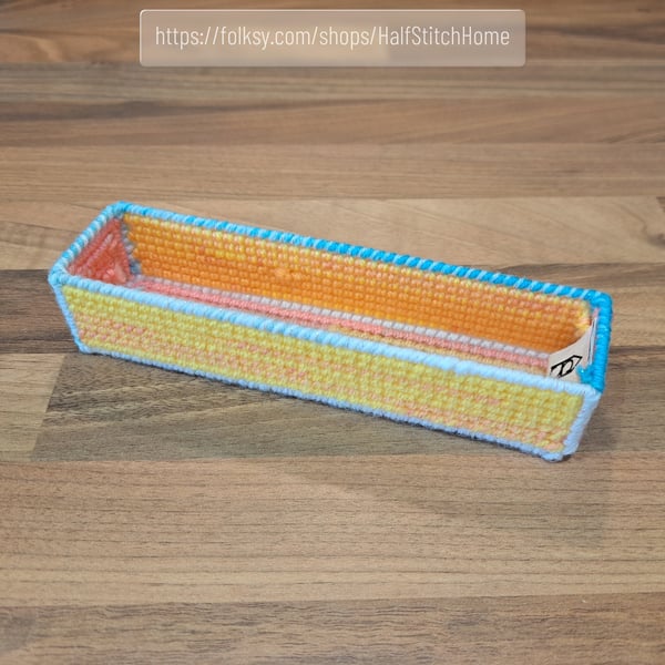 Pencil case - yellow, orange, and pink with blue and white edging, open-top 