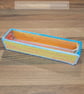Pencil case - yellow, orange, and pink with blue and white edging, open-top 