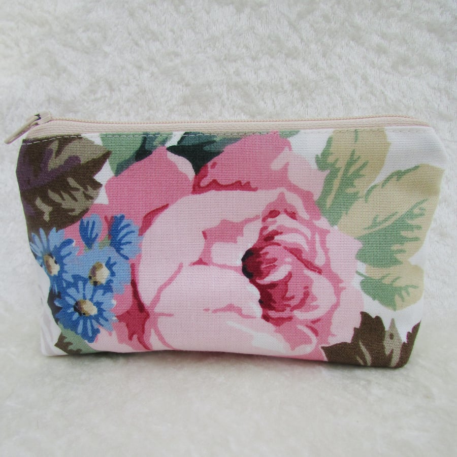 Large purse in floral fabric featuring a pink rose