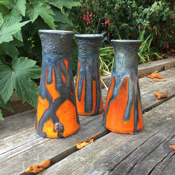 Tubular retro design vase decorated in a Black Lava Glaze and vibrant Orange 