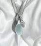 Sea glass necklace, Aqua  blue in colour, silver plated pine cone charm. 