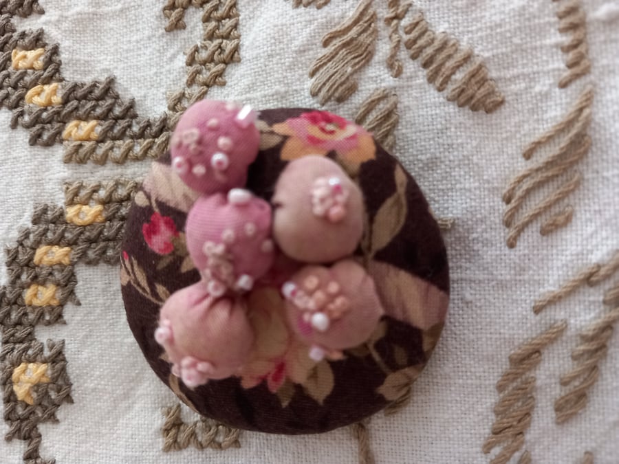 Decorated puffball hand-stitched brooch