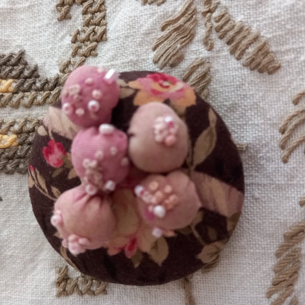 Decorated puffball hand-stitched brooch