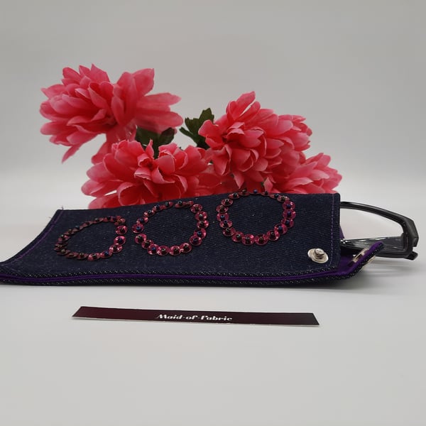 Glasses case, denim, pink circles and purple lining. 