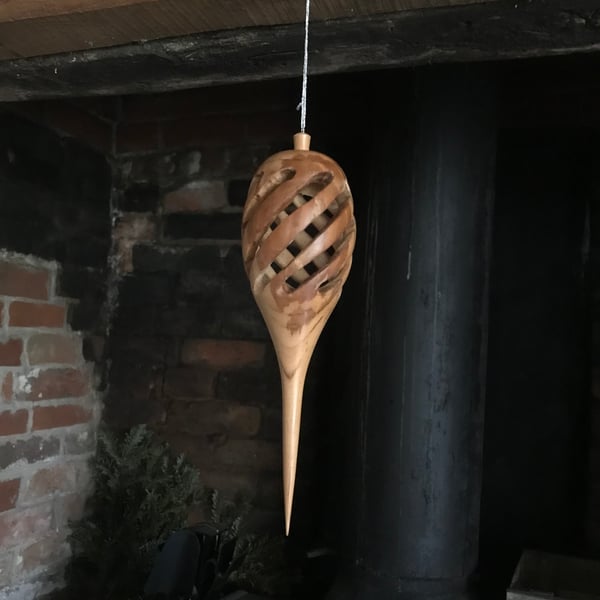 Hand turned, hollow, pierced hanging decoration