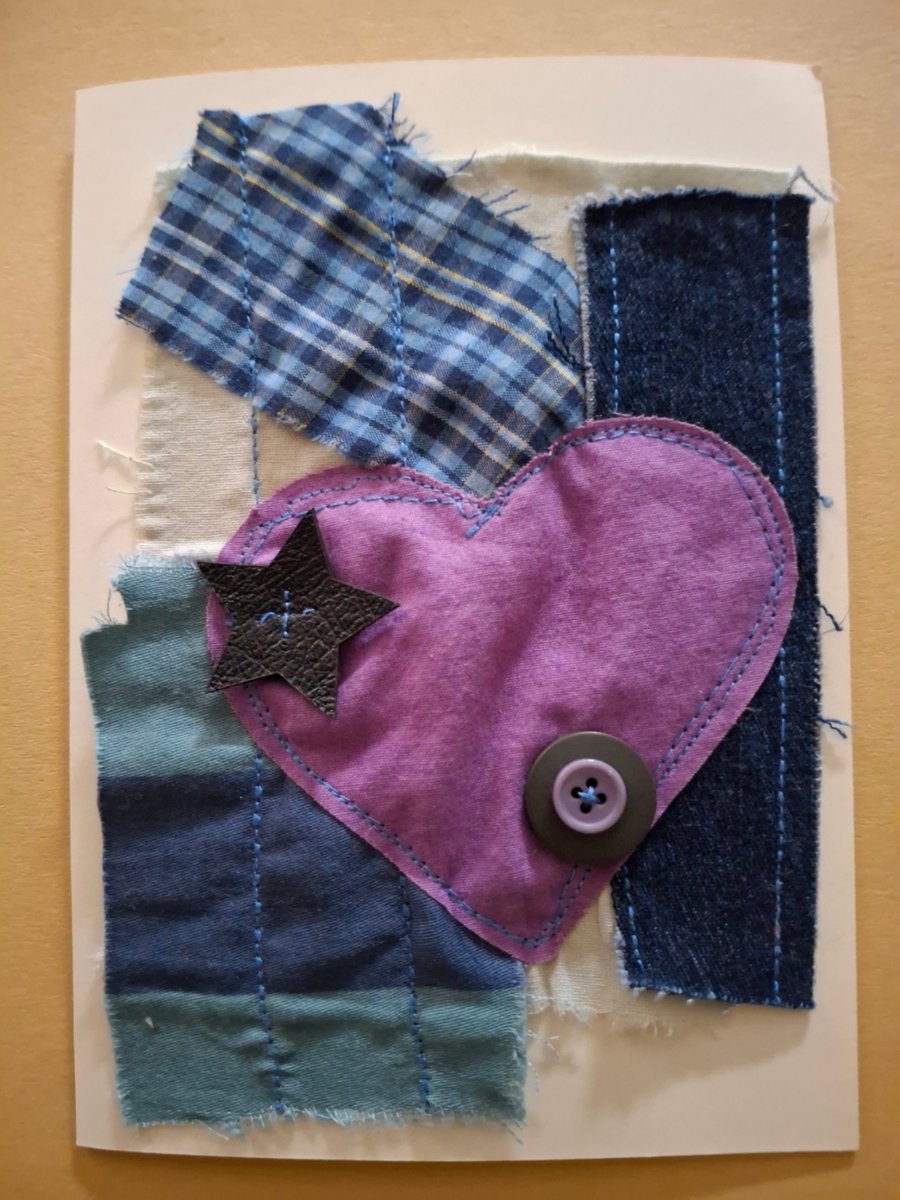 Leather flowers, flower buttons on fabric greetings card