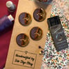 Set of 4 handcrafted ceramic buttons in smoky purple and amber