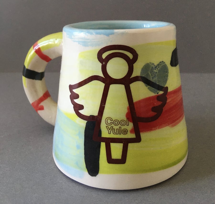 Handmade Festive cup with angel “Cool Yule” decoration.