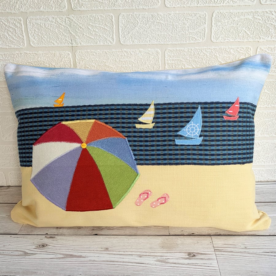 SOLD - Beach scene cushion with parasol and yachts