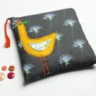 Black thistle print make-up bag with appliquéd orange bird