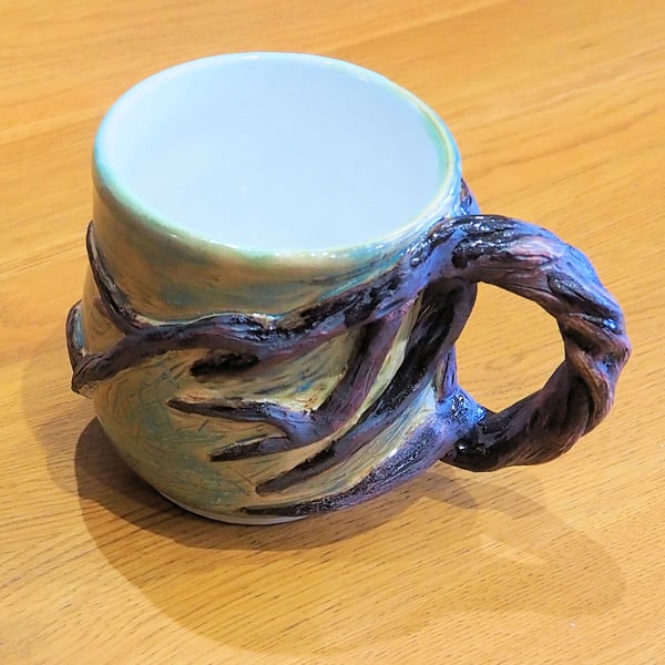 Pottery tree mug finished in green and brown bark colour glazes