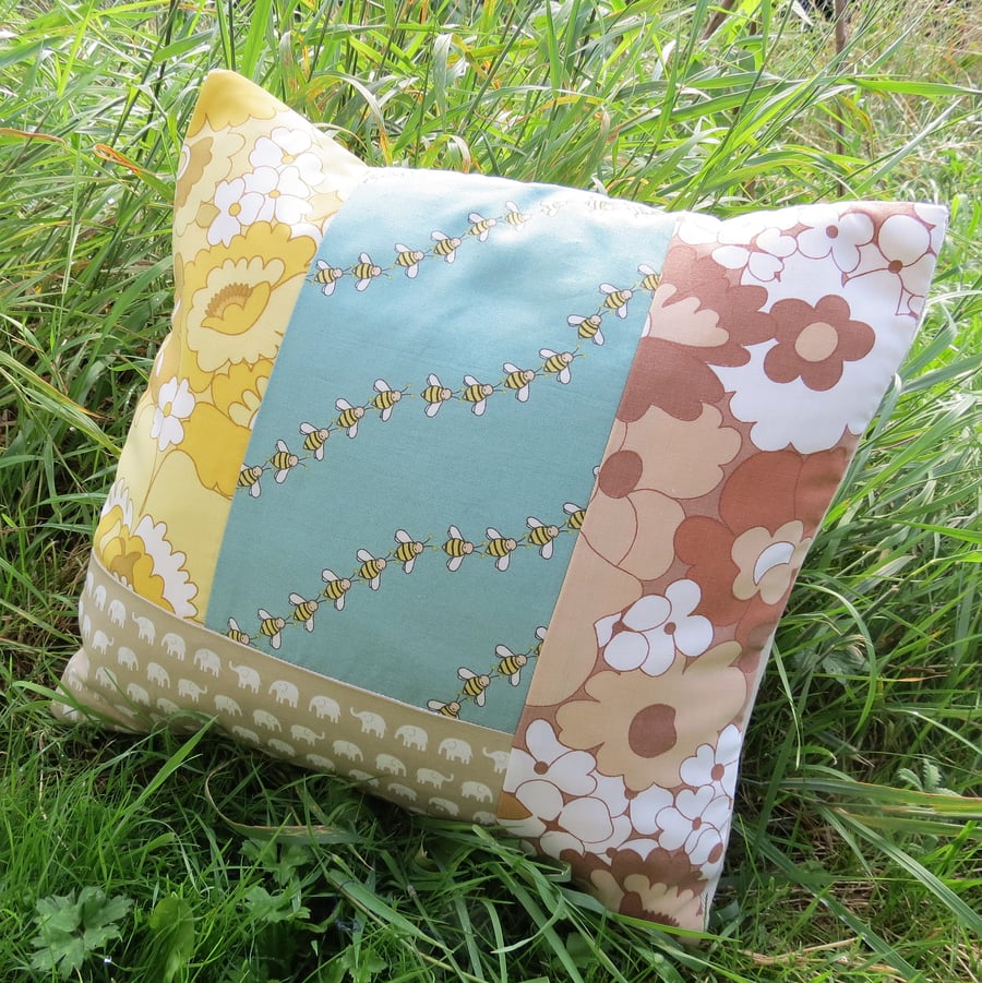 Hues of summer.  A patchwork cushion complete with feather pad.