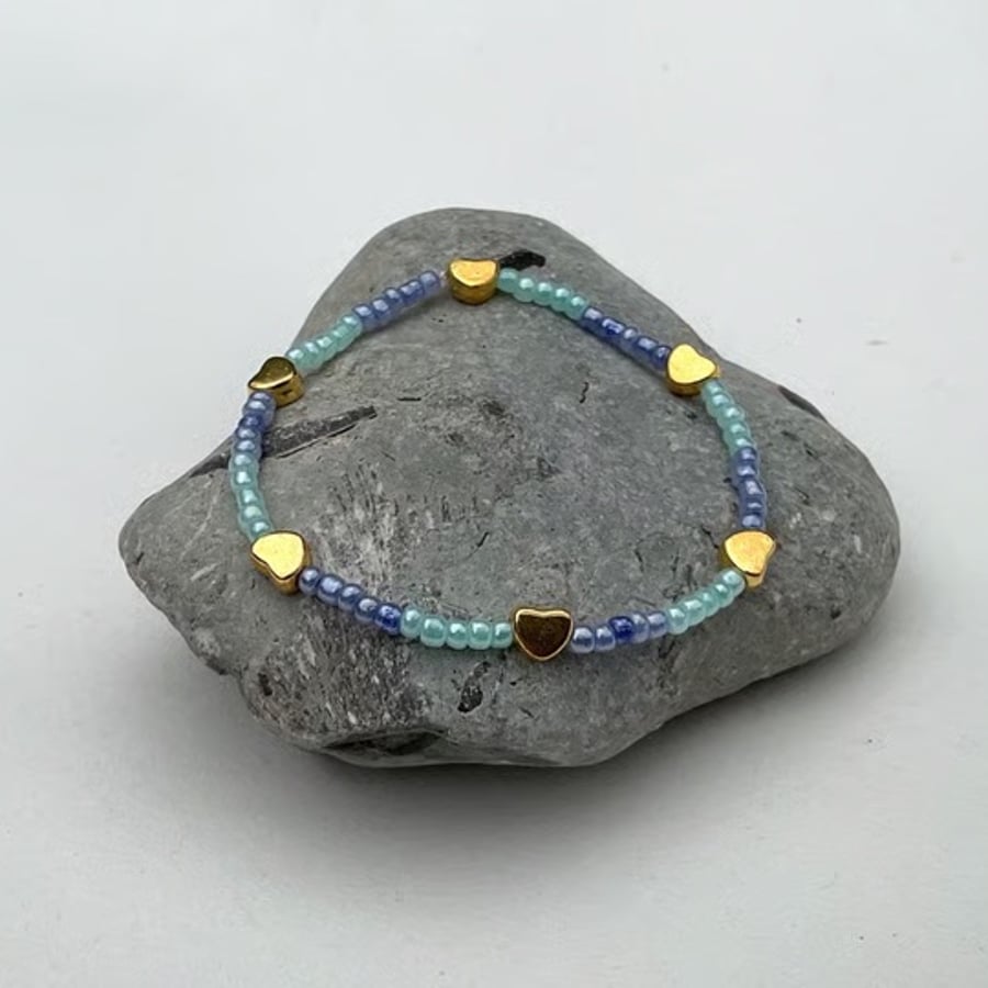 Beaded bracelet stackable blue beads with gold charms 