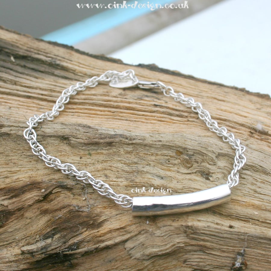 Rope style bracelet with a sterling silver textured tube