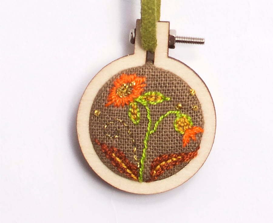 Mini hoop embroidery with hand stitched flowers on brown linen