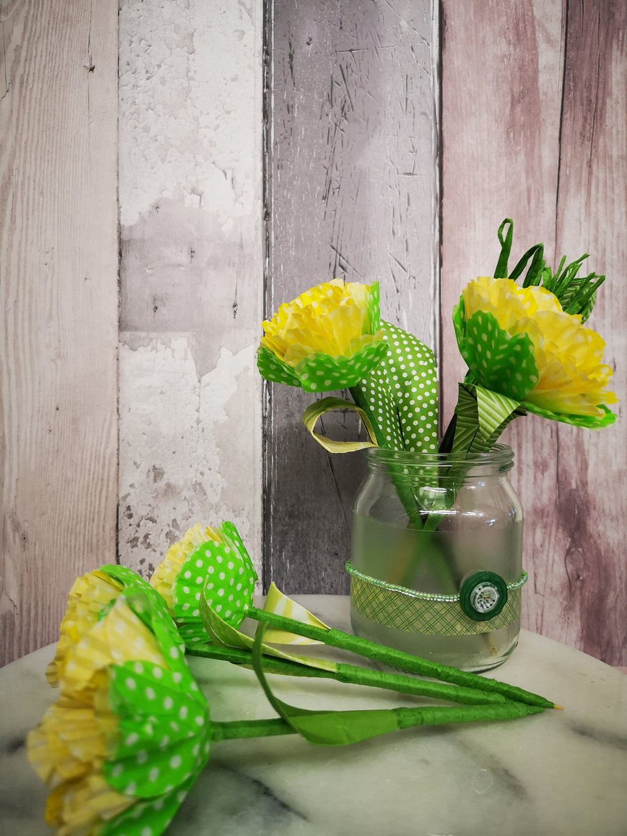 5 yellow and white polka dot paper flowers, in a decorated glass jam jar vase