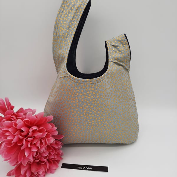 Japanese knot bag, small,  reversible in denim and gold dot fabric.  