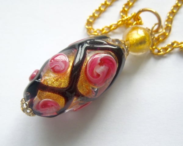 Murano glass black and gold rose pendant with gold chain.