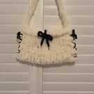 Beautiful hand knitted handbag with bow details in cream