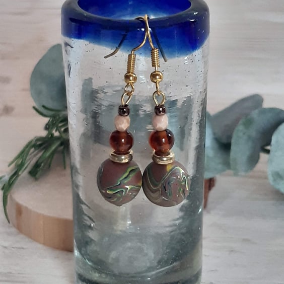 Dangly polymer clay earrings in a brown swirl design