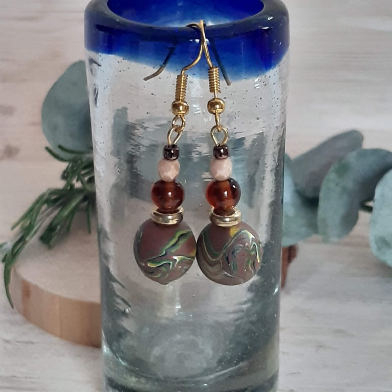 Dangly polymer clay earrings in a brown swirl design