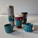 Reversible Cup Sleeve for Disposable and Travel Cups.