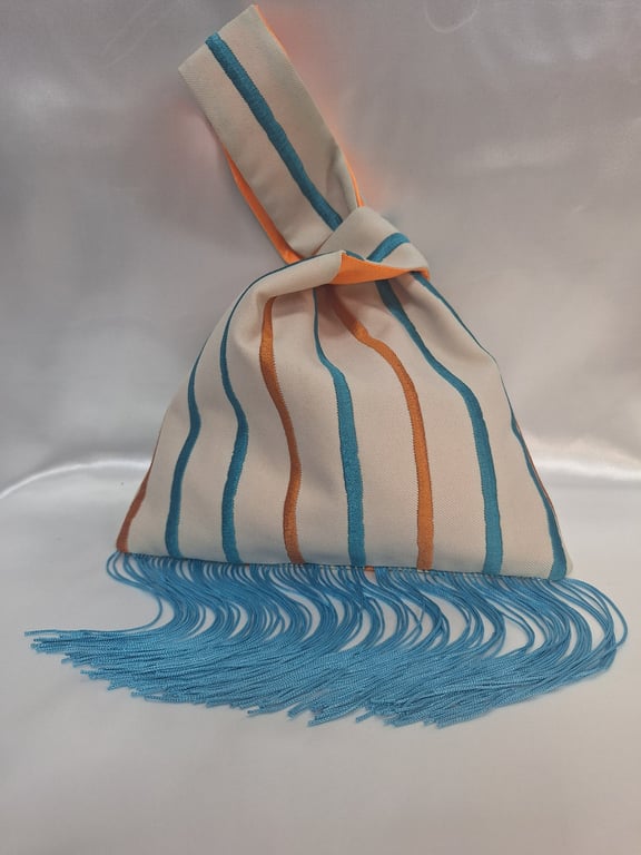  Striped patterned Japanese Knot bag with turquoise 13cm tassel trim.