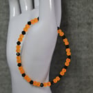 UV Reactive Orange Glass Bead and Black Glass Bicone Elastic Bracelet