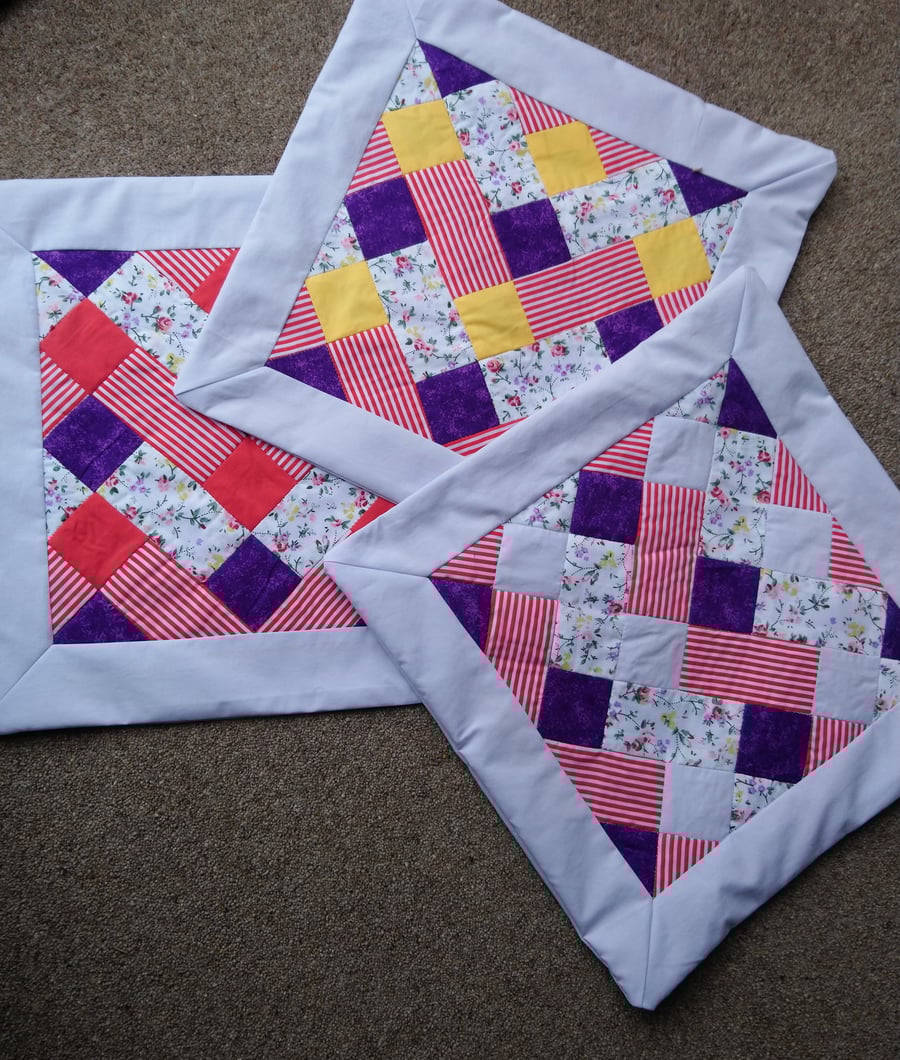 Patchwork cushion covers in red, yellow and purple. Three  available. 
