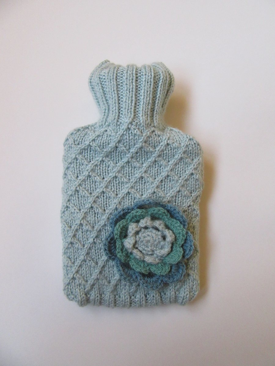 Hot water bottle cover - garden trellis with crocheted flower