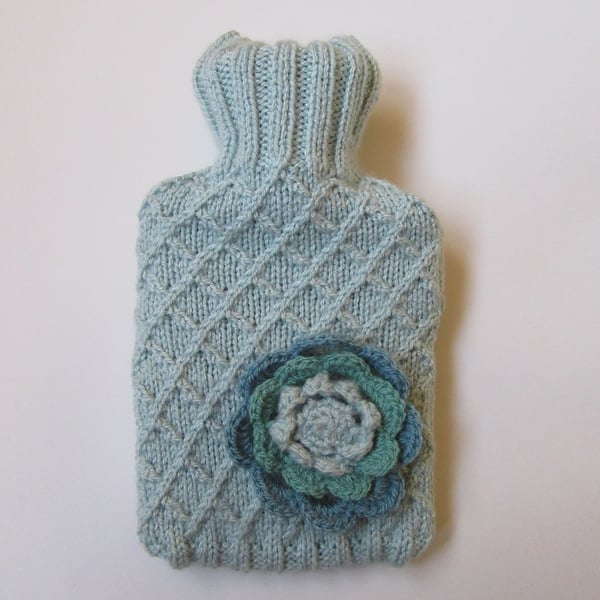 Hot water bottle cover - garden trellis with crocheted flower