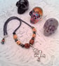 Skull & Crossbones Pendant on a Purple Bead and Skull Bead Necklace, Halloween