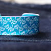 Blue aluminium cuff with seed head pattern