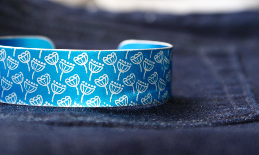 Blue aluminium cuff with seed head pattern
