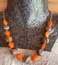 Handmade necklace in orange, black and white polymer clay - Image 1