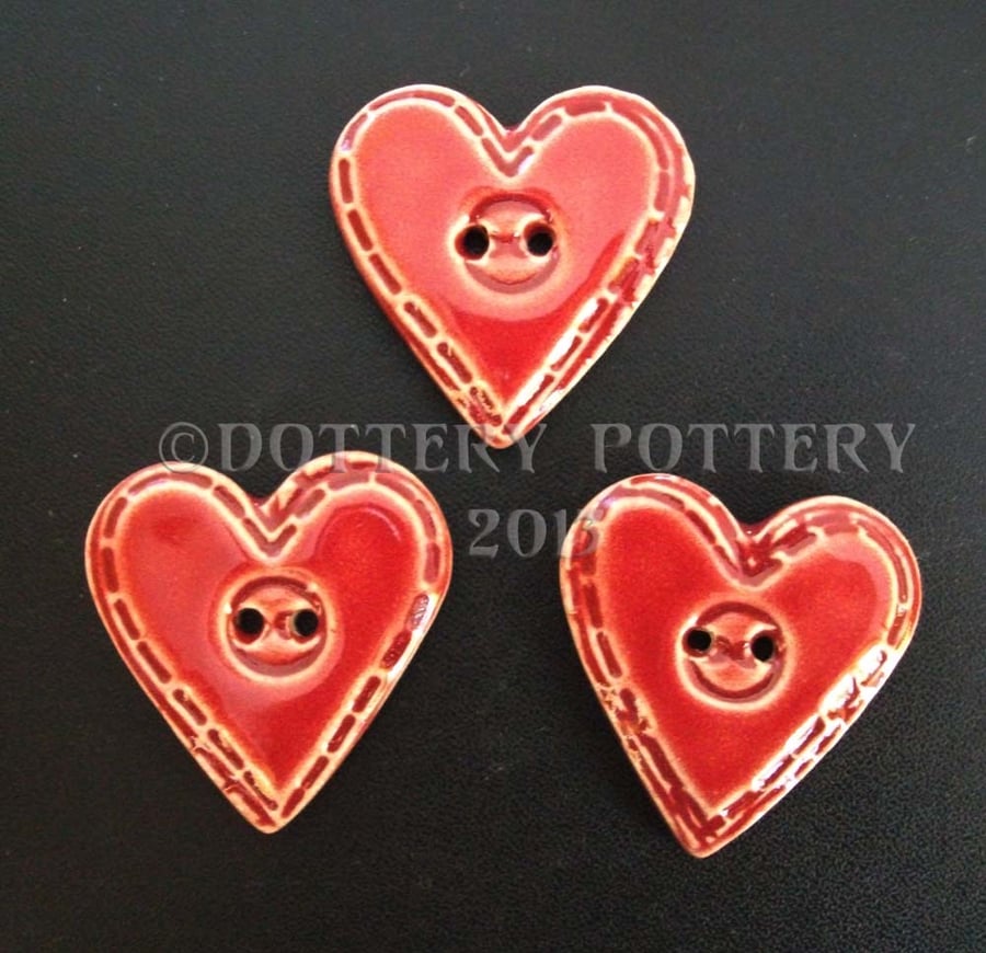 Set of three large red ceramic heart buttons