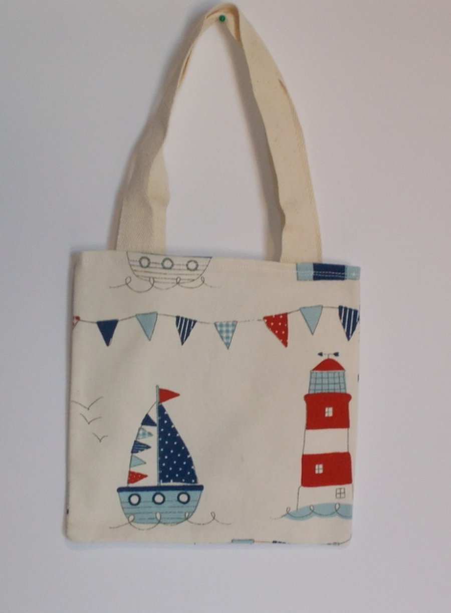 Mini tote bag printed with beach huts and lighthouses